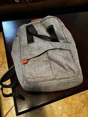 Grey backpack with tan leather trim