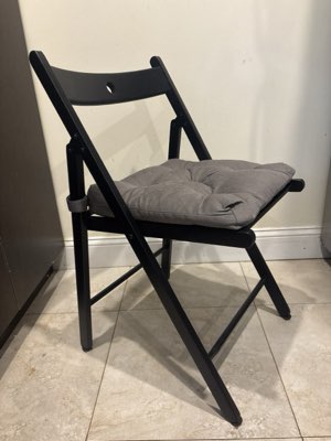 Black IKEA folding chairs with cushions, set of six