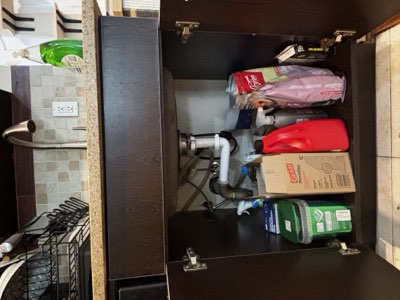 Cleaning cupboard lot: soap, sponges, bags and detergents