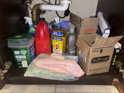 Cleaning cupboard lot: soap, sponges, bags and detergents