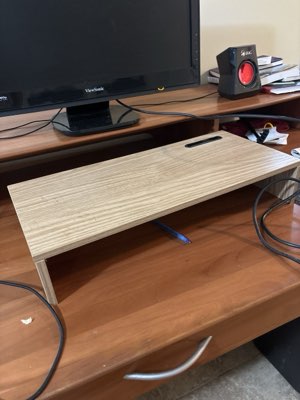 Monitor riser in pale wood, with a cable slot