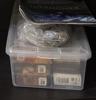 Magic: the Gathering cards in a clear storage box